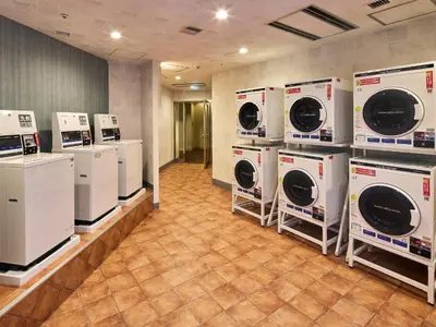 a laundry room with several washers and dryers on display at Grand Nikko Tokyo Bay Maihama in Urayasu