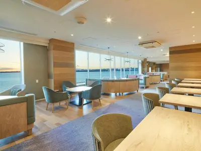 a restaurant with tables and chairs and the ocean at Grand Nikko Tokyo Bay Maihama in Urayasu