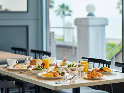 a table with plates of food and glasses of orange juice at Grand Nikko Tokyo Bay Maihama in Urayasu