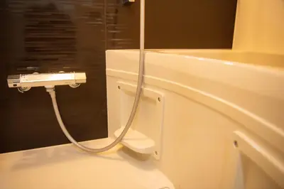 a bathroom with a shower with a white toilet at H.W.HILLS.103 in Tokyo