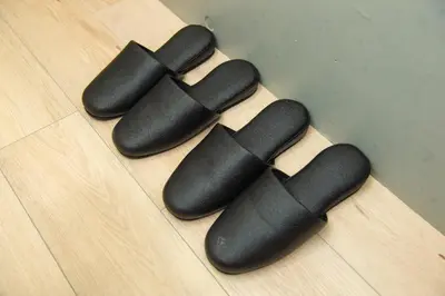 four black bowling balls on a wooden floor at H.W.HILLS.103 in Tokyo