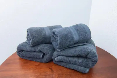 a pile of towels sitting on top of a table at H.W.HILLS.103 in Tokyo