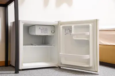 a white refrigerator with its door open in a room at Otsuka Town Hotel in Tokyo