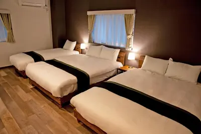 a hotel room with two beds and a window at American Vintage Suite in Tokyo