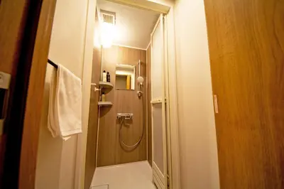 a bathroom with a shower with a light on at American Vintage Suite in Tokyo