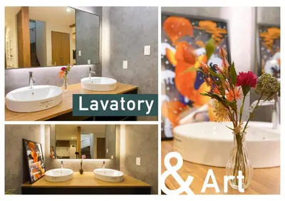a bathroom with a sink and a vase of flowers at nestay villa tokyo shinjuku in Tokyo