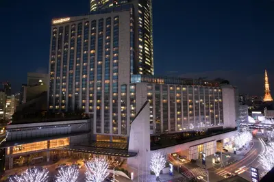 a large building at night with lights at Grand Hyatt Tokyo in Tokyo