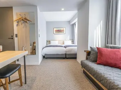 a hotel room with a bed and a couch at Bay Hotel Tokyo Hamamatsucho in Tokyo