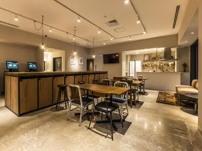 a restaurant with tables and chairs and a bar at Bay Hotel Tokyo Hamamatsucho in Tokyo