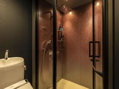 a bathroom with a glass shower with a toilet at Bay Hotel Tokyo Hamamatsucho in Tokyo