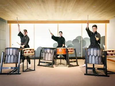 a group of men playing drums in a room at Asakusa View Hotel Annex Rokku in Tokyo