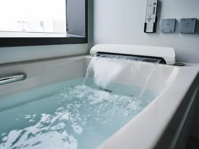 a bath tub filled with water with a window at Asakusa View Hotel Annex Rokku in Tokyo