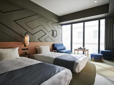 a hotel room with two beds and a window at Asakusa View Hotel Annex Rokku in Tokyo