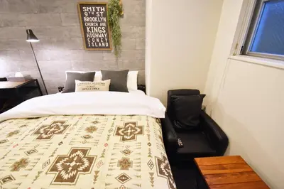 a bedroom with a bed with a quilt on it at Tune Inn Tokyo Bay in Tokyo