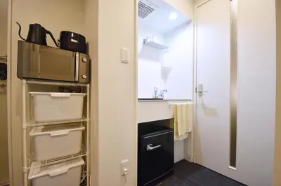a small bathroom with a sink and a microwave at Tune Inn Tokyo Bay in Tokyo