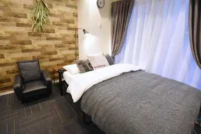 a bedroom with a bed and a chair at Tune Inn Tokyo Bay in Tokyo