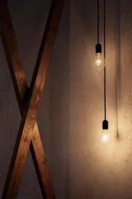 two lights hanging from a wall with a wooden ceiling at \uff35\uff27\uff2f in Tokyo