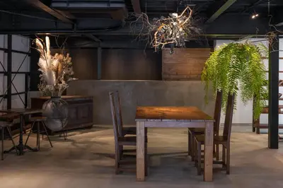 a table and chairs in a room with plants at \uff35\uff27\uff2f in Tokyo