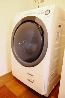 a white washing machine is sitting on the floor at \uff35\uff27\uff2f in Tokyo