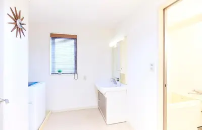 a white bathroom with a sink and a mirror at S'CASA NishiShinjuku in Tokyo