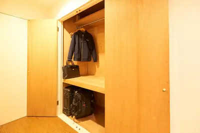 a walk in closet with a purse andpacks in it at S'CASA NishiShinjuku in Tokyo