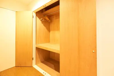 a walk in closet with wooden shelves and a door at S'CASA NishiShinjuku in Tokyo
