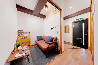 a living room with a couch and a table at Terrace Terano#101 in Tokyo