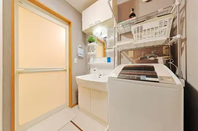 a laundry room with a washer and a sink at Terrace Terano#101 in Tokyo