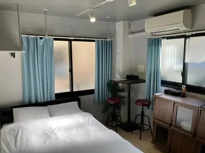 a bedroom with a bed and a desk and windows at H.W HILLS / Vacation STAY 6477 in Tokyo