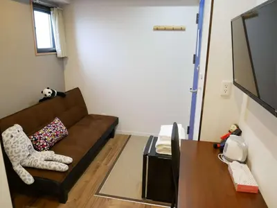 a living room with a couch and a table at Tokyo shinjukutei Hotel Asahi gruop \u6771\u4eac\u65b0\u5bbf\u4ead\u30db\u30c6\u30eb in Tokyo