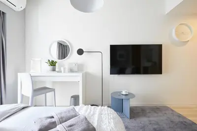 a bedroom with a bed and a tv on a wall at P OIN T - Shinjuku Kabukicho Designer's Apartment II in Tokyo