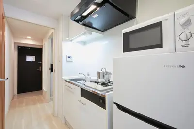 a kitchen with a sink and a refrigerator at P OIN T - Shinjuku Kabukicho Designer's Apartment II in Tokyo