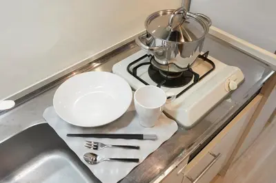 a kitchen counter with a pot on top of a stove at P OIN T - Shinjuku Kabukicho Designer's Apartment II in Tokyo