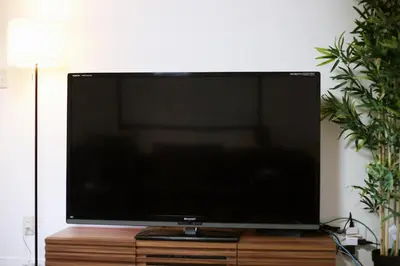 a flat screen tv sitting on a wooden stand at MUMU HOUSE in Tokyo