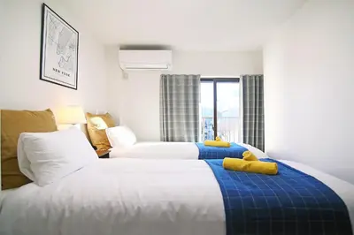 a hotel room with two beds and a window at MUMU HOUSE in Tokyo