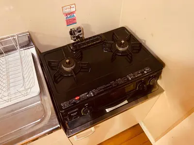 a black stove top oven sitting in a kitchen at Tokyo Stay Nakano in Tokyo