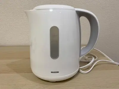 a whiteffeepot sitting on top of a table at Tokyo Stay Nakano in Tokyo