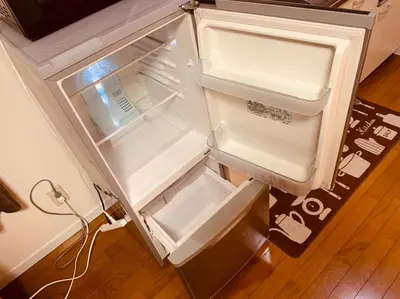 an empty refrigerator with its door open in a kitchen at Tokyo Stay Nakano in Tokyo