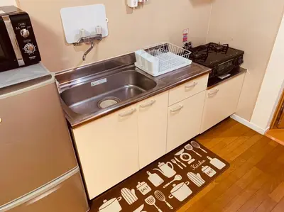 a small kitchen with a sink and a stove at Tokyo Stay Nakano in Tokyo