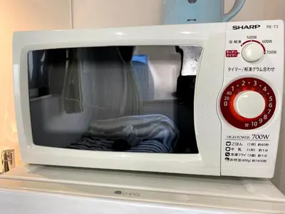 a white microwave with its door open on a counter at Belle harmonie togoshi101 in Tokyo