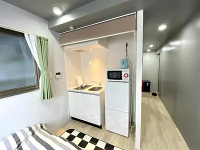 a small kitchen with a sink and a microwave at Belle harmonie togoshi101 in Tokyo