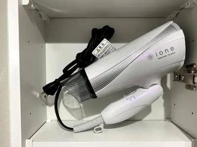 a white hairdryer in a drawer at Belle harmonie togoshi101 in Tokyo