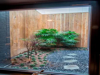 a garden in a window with a wooden fence at YADOYA Karasumain in Tokyo
