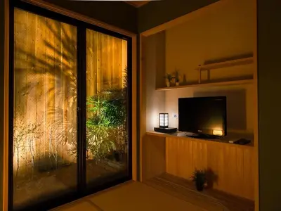 a television sitting on a shelf next to a window at YADOYA Karasumain in Tokyo