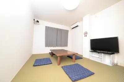 a living room with a table and a flat screen tv at ACT Residence No.1 in Tokyo