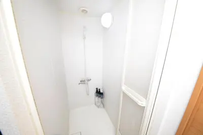 a white shower in a bathroom with a white floor at ACT Residence No.1 in Tokyo