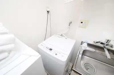 a laundry room with a washer and a washing machine at ACT Residence No.1 in Tokyo