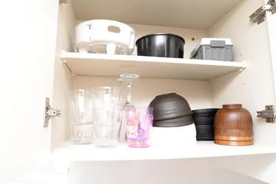 a shelf with glasses and other items on it at ACT Residence No.1 in Tokyo