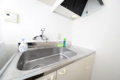 a stainless steel sink in a white kitchen at ACT Residence No.1 in Tokyo
