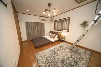 a room with a bed and a ladder at Jomira & Jony House in Tokyo